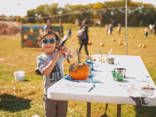 Boy Painting Pumpkin